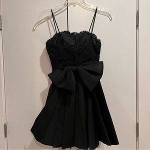 Black mini dress with lace top and bow flare